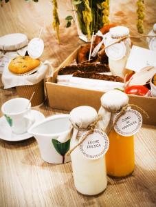 a table with two bottles of honey and a box of food at El Rincon De Jara in Caudiel