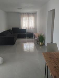 a living room with a couch and a table at דירת אירוח בקצרין in Qasrîne +1 photo