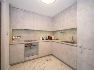 a kitchen with white cabinets and a sink at Paradise Center Premium Suite 2 in Sofia