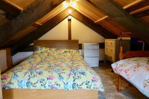 a bedroom with a bed in a attic at Glanyrafon Smithy Talgarreg in Tal-gareg