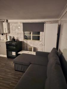 een woonkamer met een bank en een keuken bij Immaculate 3-Bed Chalet in Sheerness in Sheerness