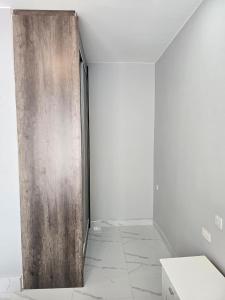 a wooden door in a room with a white wall at Modern Village Apartments in Chipata