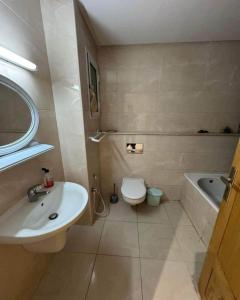 a bathroom with a sink and a toilet and a tub at EZZAYATINE in Tunis
