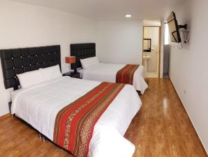 Postel nebo postele na pokoji v ubytování Cusco de mis Sueños Hostal - II