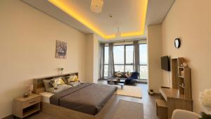a bedroom with a bed and a living room at Private Studio Burj Khalifa Area -BEST PRICE in Dubai