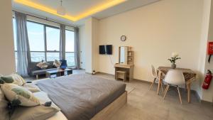 a bedroom with a bed and a desk and a table at Private Studio Burj Khalifa Area -BEST PRICE in Dubai