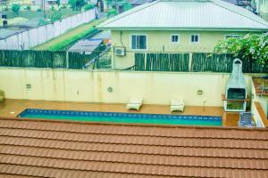 two benches on top of a building with a fence at LJ's Place in Lagos
