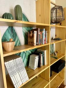 une étagère en bois avec des livres dans l'établissement Appartement calme avec jardin proche de Paris, à Évry-les-Châteaux