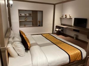 a bedroom with a large bed and a desk at Narwar Lakefront Resort in Shivpurī