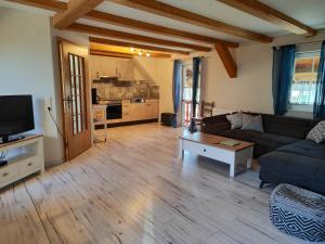 a living room with a couch and a table at Ferienwohnung Heuboden in Amtzell