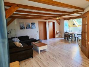 a living room with a couch and a table at Ferienwohnung Heuboden in Amtzell
