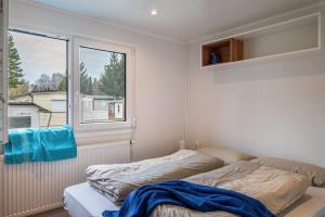 a bedroom with a bed and a window at Haus Zander in Lohmen