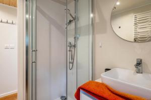 a bathroom with a sink and a shower at Haus Zander in Lohmen +14 photos
