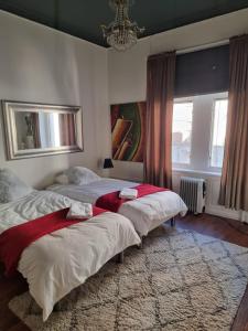 a bedroom with two beds and a chandelier at Stockholm Central City Apartment! in Stockholm