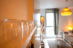 a room with a row of glasses on a counter at Le Caducé / Proche Deux Lions in Tours