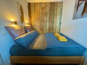 a bed in a room with two yellow towels on it at 3-Room Apartment with sauna and pool & walk to slopes - JokerCard included in Saalbach Hinterglemm +22 photos