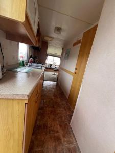 a small kitchen with a counter and a hallway at AMS Caravan Holidays in Ingoldmells