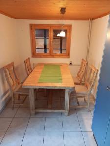 einen Esstisch und Stühle in einem Zimmer in der Unterkunft Chalet Bärenhaus in Sigriswil