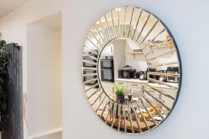 a mirror in a kitchen with a spiral staircase at Luxurious 3 Bedroom Apartment in Park Estate in Nottingham