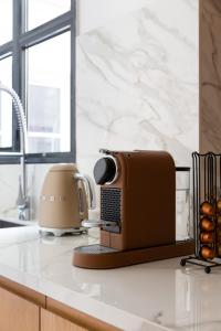 a toaster and coffee maker on a kitchen counter at HIGHSTAY - Luxury Serviced Apartments - Place Vendôme Area in Paris