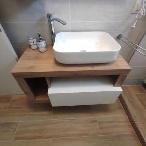 a sink on a wooden table in a bathroom at Onda Marina 2 in La Spezia