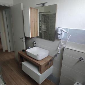 a bathroom with a white sink and a mirror at Onda Marina 2 in La Spezia