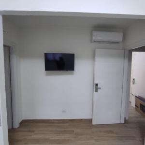 a white room with a flat screen tv on a wall at Onda Marina 2 in La Spezia