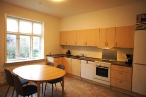 a kitchen with a wooden table and a table and a dining room at (id 055). Finlandsgade 41. First floor in Esbjerg