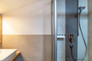 a shower with a glass door in a bathroom at Appartement by Blahut Vacation - dg in Ehrwald +8 photos