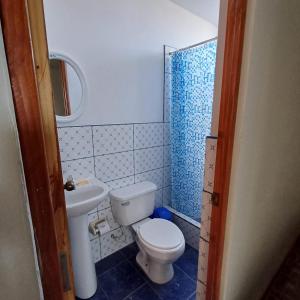 a bathroom with a toilet and a sink at El Capricho II Paracas in Paracas
