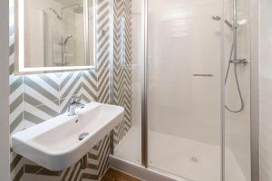 a bathroom with a sink and a shower at Le Carline, Sure Hotel Collection by Best Western in Caen