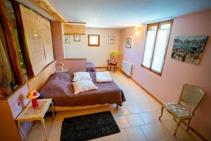 a bedroom with a bed and a table and chairs at Chambre d'hôtes - Le jardin des Patissons in La Foret Du Parc