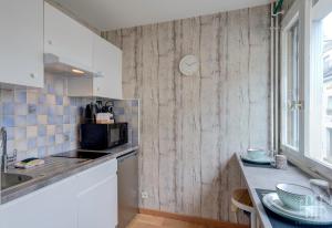 a kitchen with a counter and a sink and a microwave at Le Prébendes / Parc Prébendes in Tours