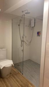 a shower stall in a bathroom with a toilet at Jeboutiquelangsuan hotel in Lang Suan