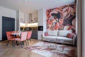 a living room with a couch and a table at Carvala Boutique Apartments in Częstochowa