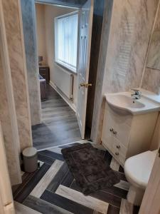 a bathroom with a sink and a toilet at Stunning 5-bed ensuite House Solihull in Solihull