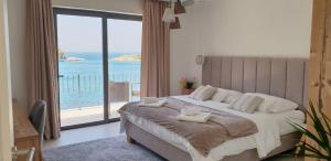 a bedroom with a bed with a view of the ocean at Guesthouse Augusta Insula in Lastovo