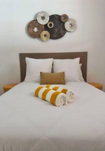 a white bed with two donuts on top of it at Villa Tropicana in Rémire-Camp