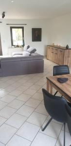 a bedroom with a bed and a table and a desk at appartement Courcelles in Courcelles