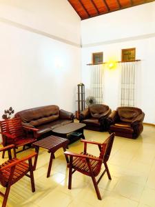 a living room with a couch and chairs and a table at Matara Near Polhena & Mirissa Three Story House in Matara
