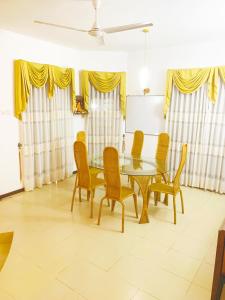 a dining room with a table and chairs at Matara Near Polhena & Mirissa Three Story House in Matara