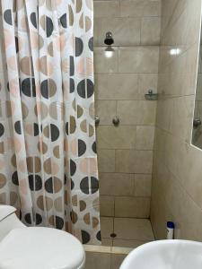 a bathroom with a toilet and a shower at Departamento interior 1er piso. in Cajamarca