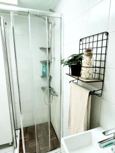 a bathroom with a shower and a sink at Casa de praia in Estoril