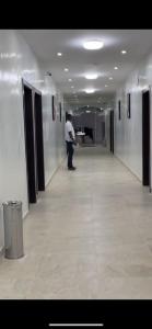 a man standing in a hallway in a building at HOTEL ZOUERATE in Zouérat