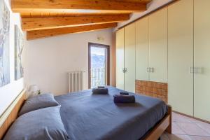 a bedroom with a large bed with two towels on it at LAGO DI COMO - Luxury Panoramic Garden - Free Wifi in Gera Lario