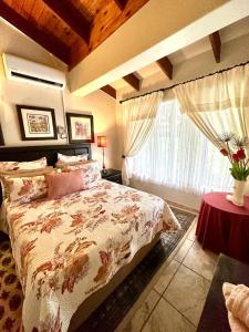 a bedroom with a large bed and a window at MaBella in Richards Bay