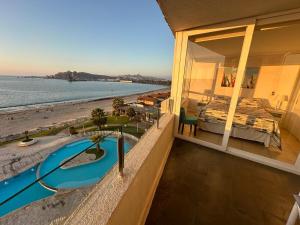 a house with a swimming pool and a view of the beach at Playa La Herradura - La Serena in Coquimbo