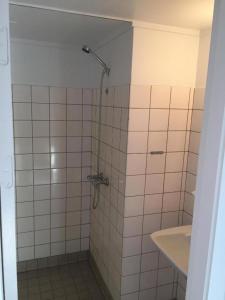 a bathroom with a shower and a sink at 62N Guesthouse Marknagil in Tórshavn