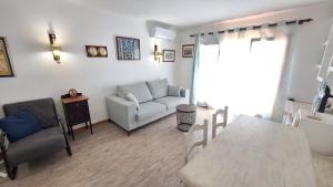 a living room with a couch and a table at La Font Lovely apartment LEstartit 400 meter from the beach in L'Estartit