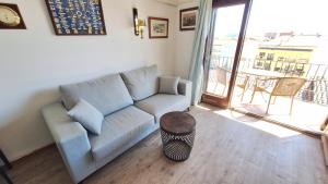 a living room with a couch and a table at La Font Lovely apartment LEstartit 400 meter from the beach in L'Estartit +53 photos